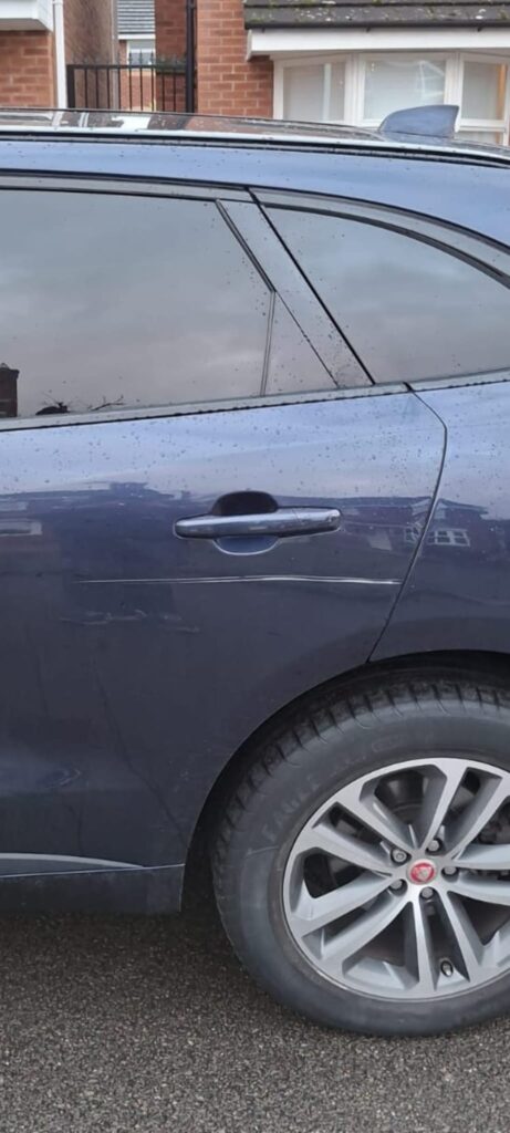 Car scratch repair on vehicle door panel